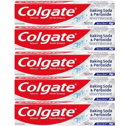 Multiple boxes of Colgate Baking Soda & Peroxide Whitening toothpaste stacked on a white background.