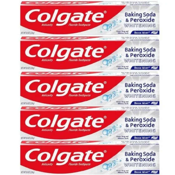 Multiple boxes of Colgate Baking Soda & Peroxide Whitening toothpaste stacked on a white background.