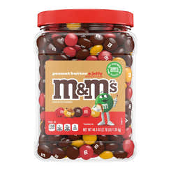 A jar of M&M's Peanut Butter & Jelly Chocolate Candies with a red lid and a label showing the M&M character and the flavor details.