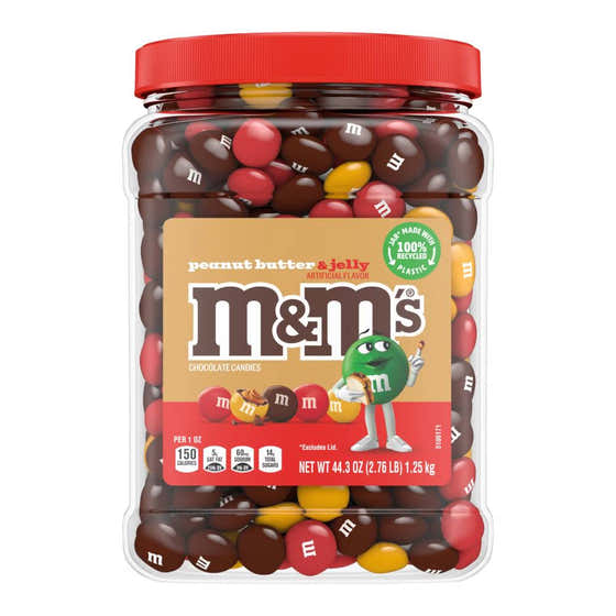 A jar of M&M's Peanut Butter & Jelly Chocolate Candies with a red lid and a label showing the M&M character and the flavor details.