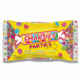 A bag of Smarties Parties candy with a yellow background, featuring the Smarties logo and colorful candy rolls displayed.